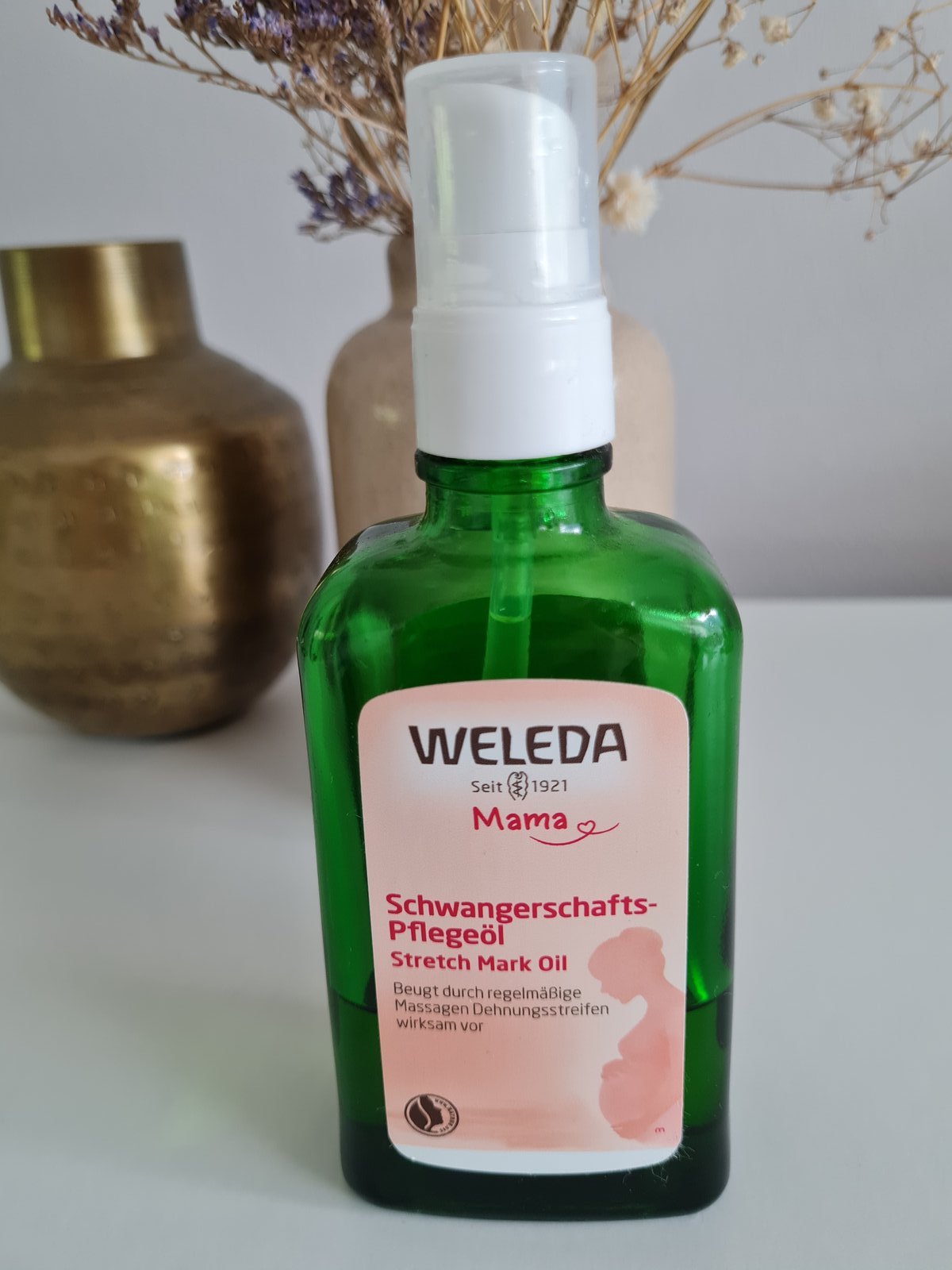 Weleda Schwangerschafts-Pflegeöl 100 ml mit Pumpspender in grüner Glasflasche